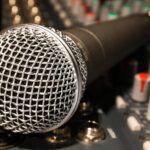 Close-up of a broadcast microphone in a studio.