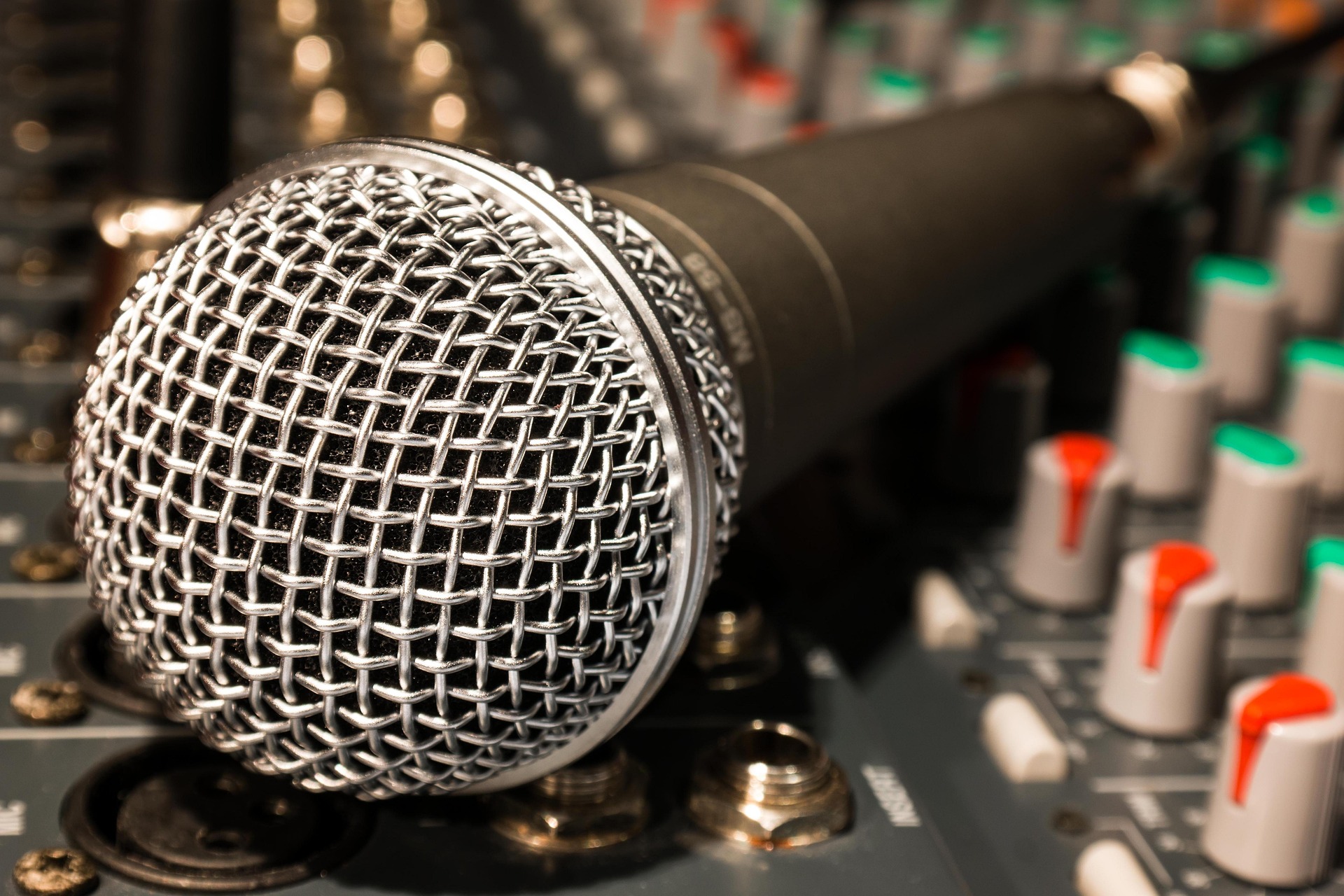 Close-up of a broadcast microphone in a studio.