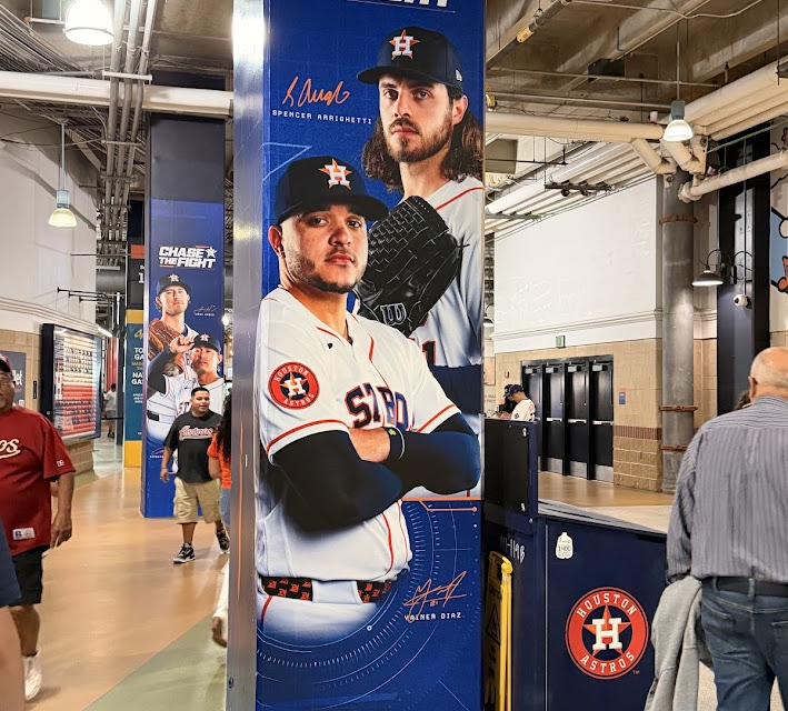 A banner at Daikin Park with the Astros' 2026 slogan, "Chase the Fight", on it.