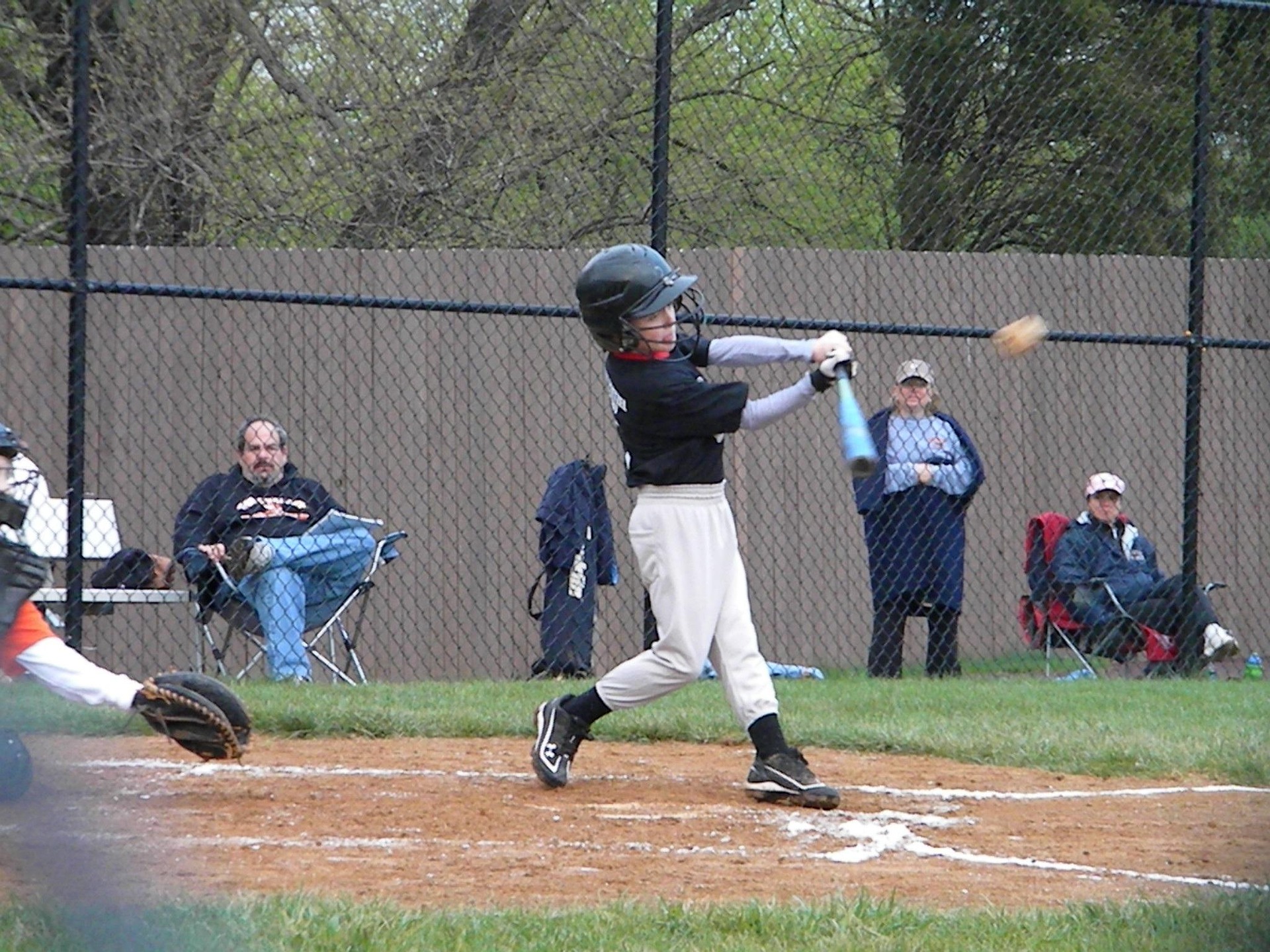 A batter takes a swing at a baseball.