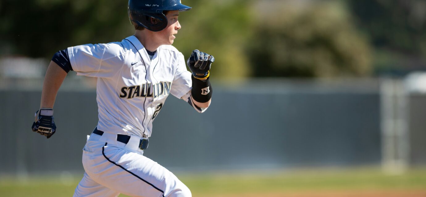 A baseball player running on a baseball field.