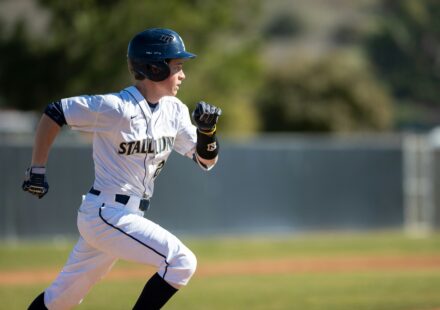 A baseball player running on a baseball field.