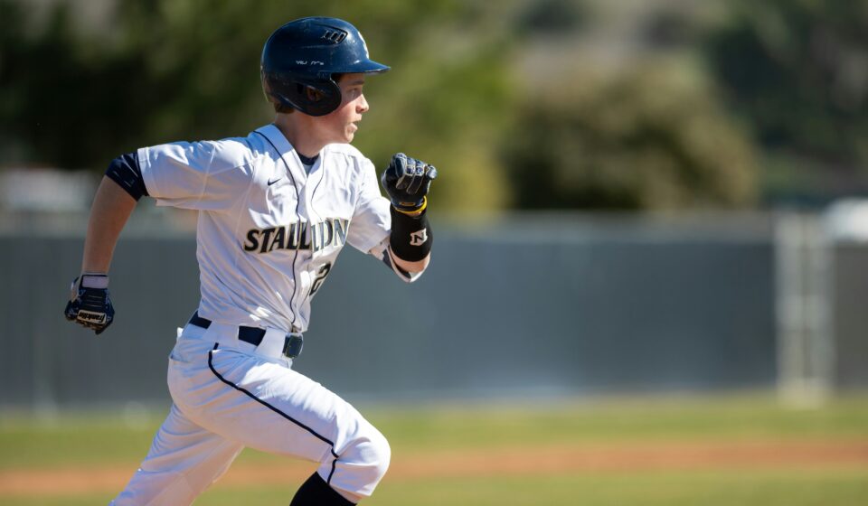 A baseball player running on a baseball field.