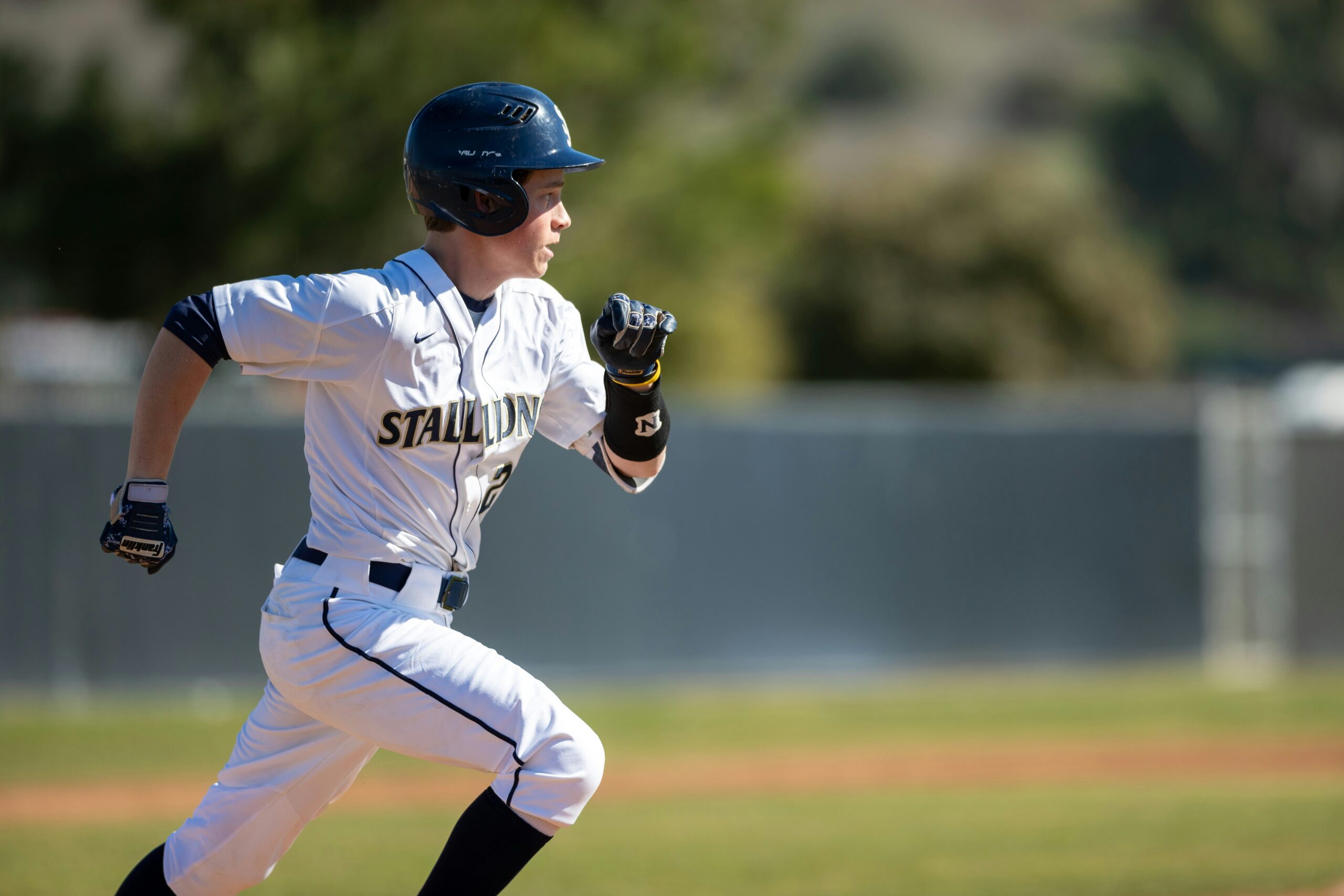 A baseball player running on a baseball field.