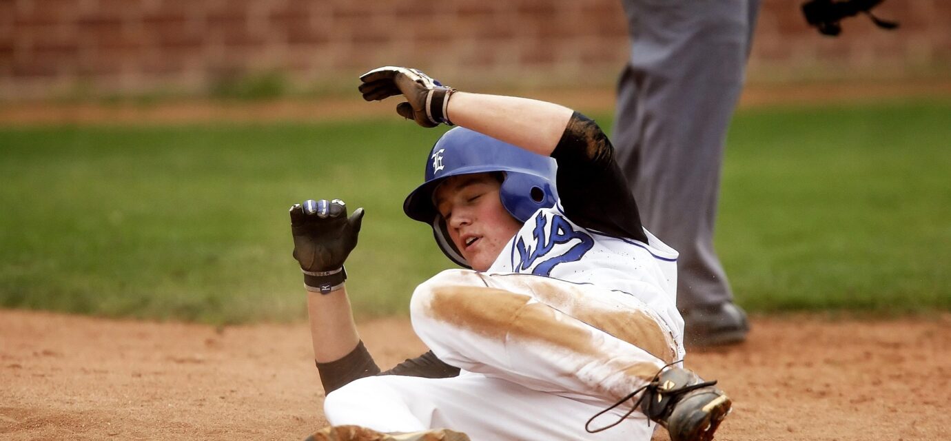 A baseball player slides into base.