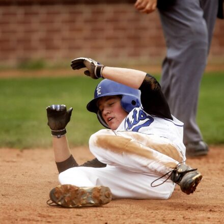 A baseball player slides into base.