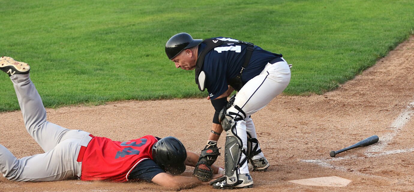 A runner is tagged out at the base.