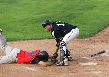 A runner is tagged out at the base.