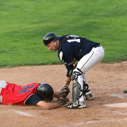 A runner is tagged out at the base.