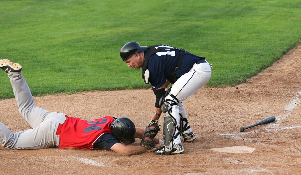 A runner is tagged out at the base.