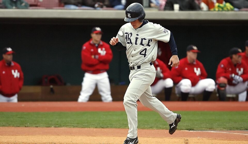 A baseball player trots triumphantly to home plate.