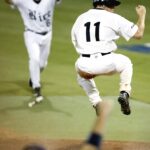 Two baseball players celebrate on the field.