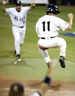Two baseball players celebrate on the field.