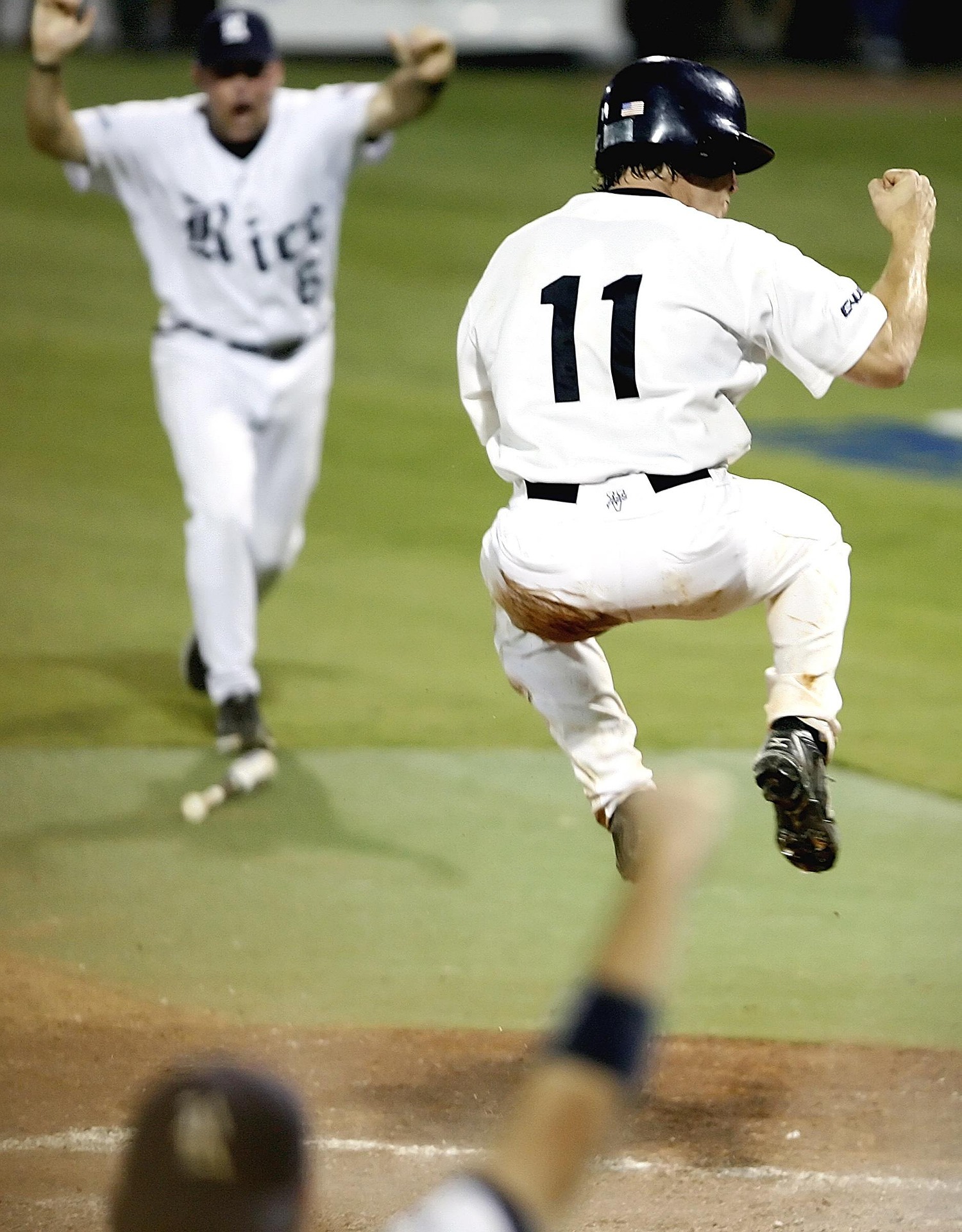 Two baseball players celebrate on the field.
