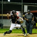 A catcher at home plate winds up to throw the ball.