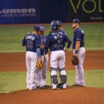 Several players gather on the pitcher's mound for a conference.