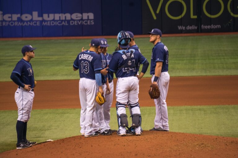 Several players gather on the pitcher's mound for a conference.