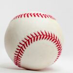 A baseball stands out against a white background.