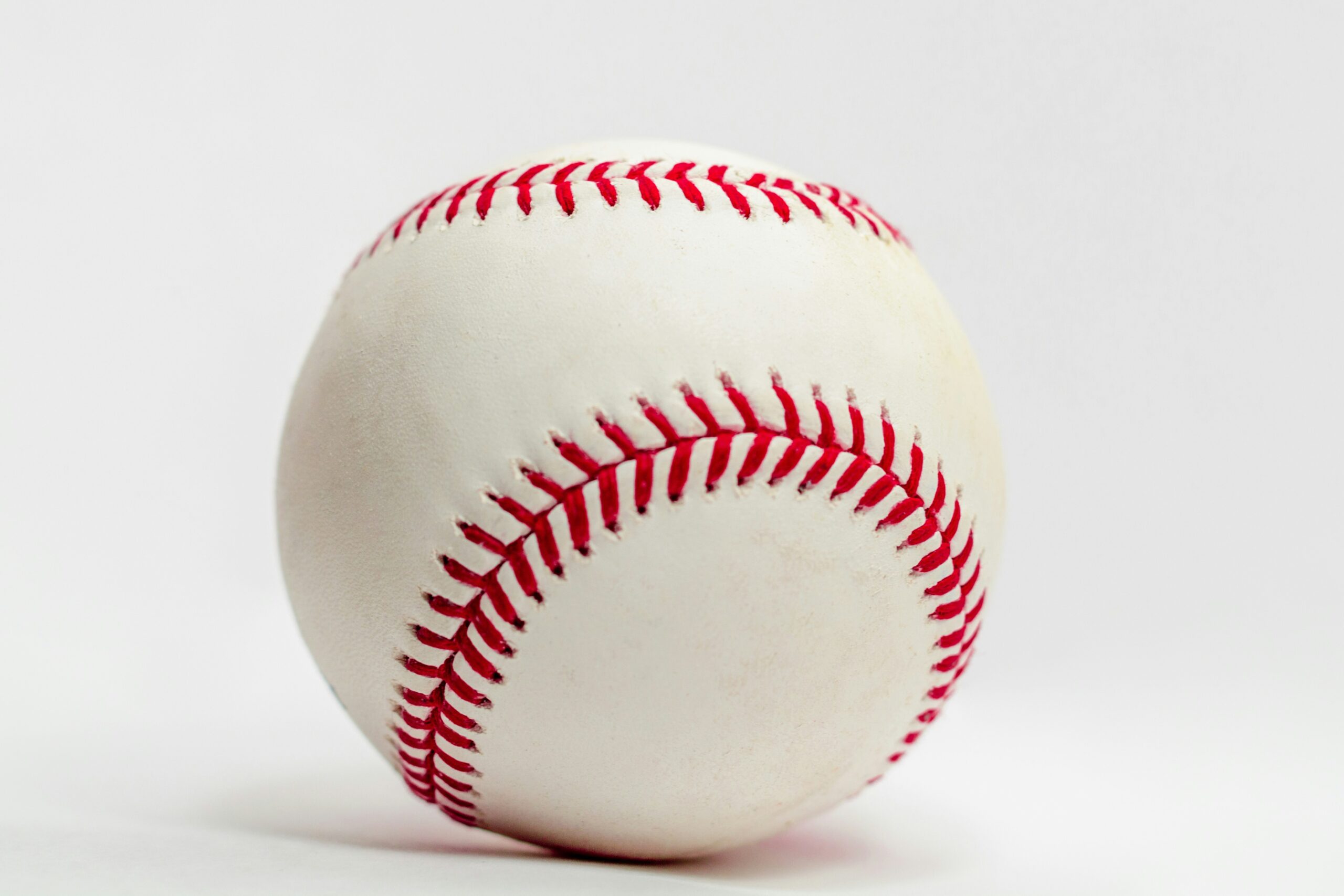 A baseball stands out against a white background.