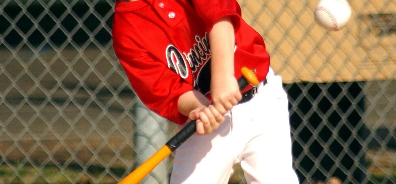 A batter is at home plate, ready to swing.