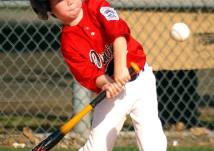 A batter is at home plate, ready to swing.