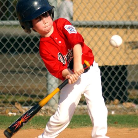 A batter is at home plate, ready to swing.