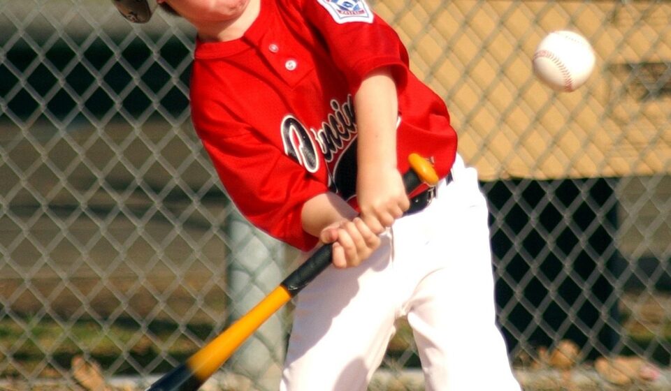 A batter is at home plate, ready to swing.