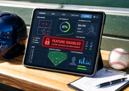 Baseball dugout tablet displaying a disabled analytics feature alongside a batting helmet, baseball and lineup card.