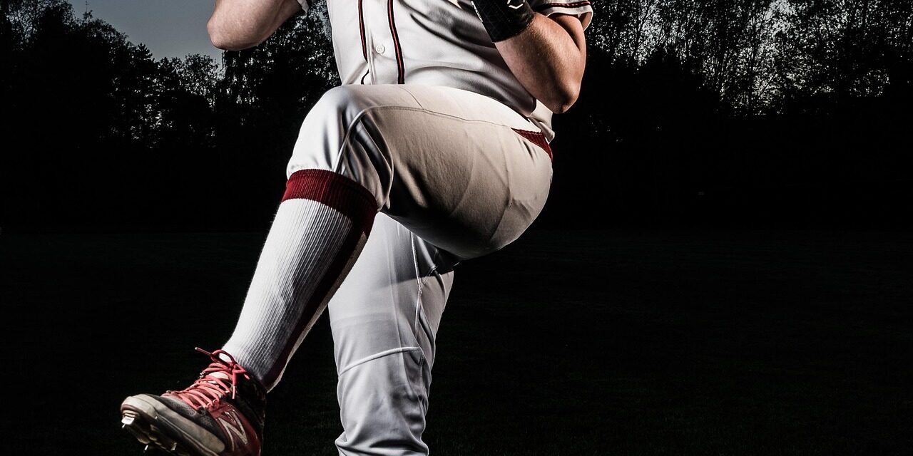 A pitcher is winding up, prior to release.