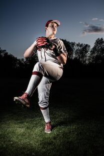 A pitcher is winding up, prior to release.