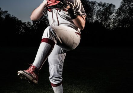 A pitcher is winding up, prior to release.