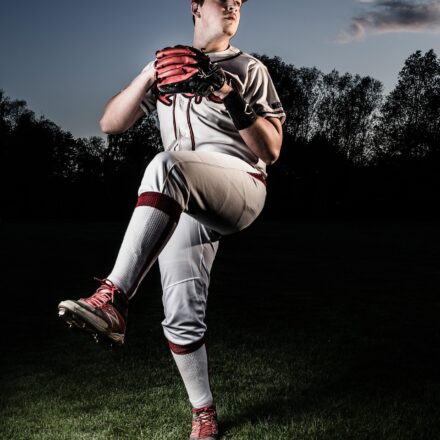 A pitcher is winding up, prior to release.