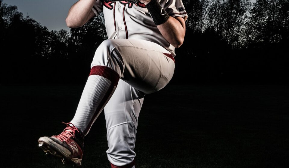 A pitcher is winding up, prior to release.