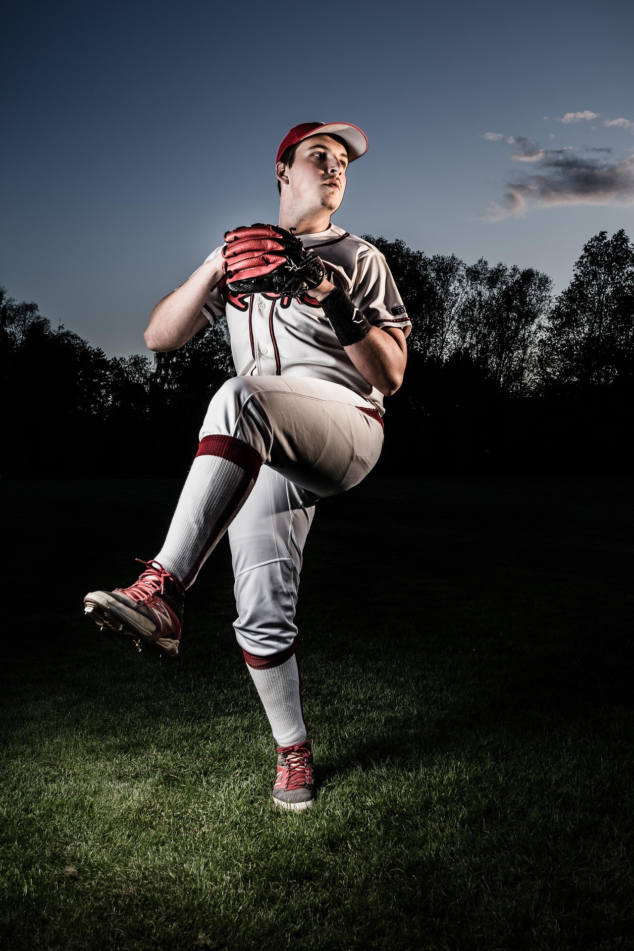 A pitcher is winding up, prior to release.