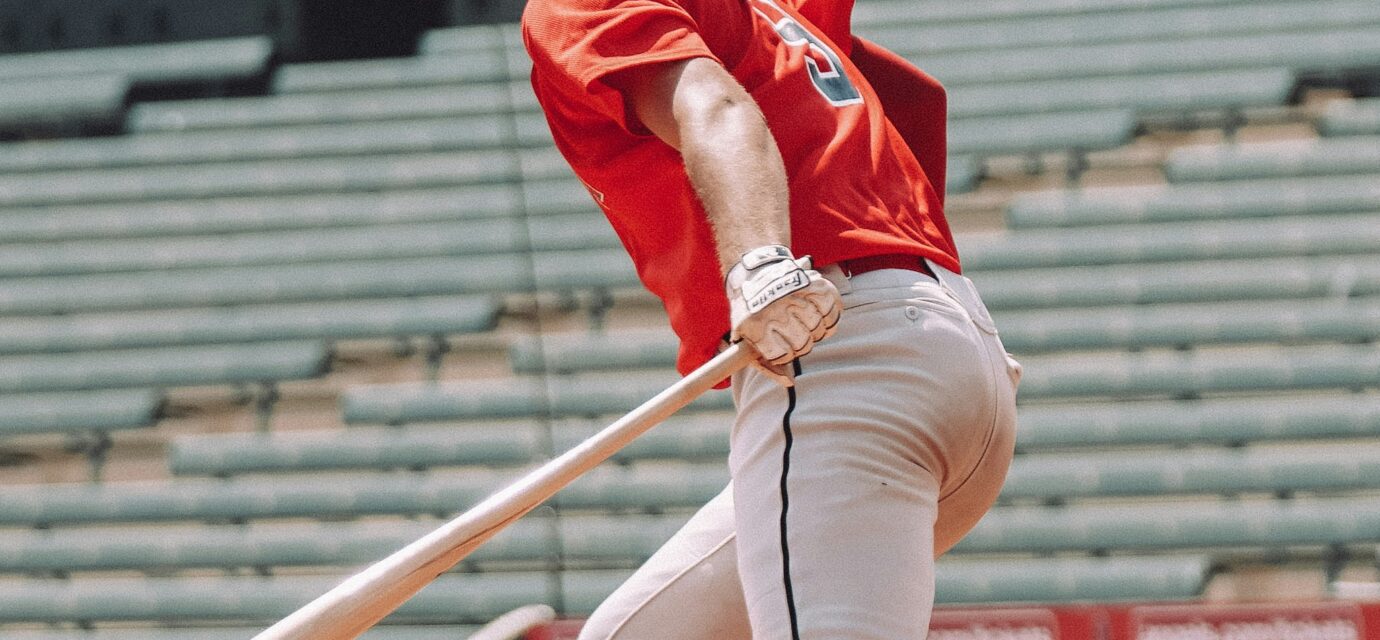 A baseball player is ready to run to first base.