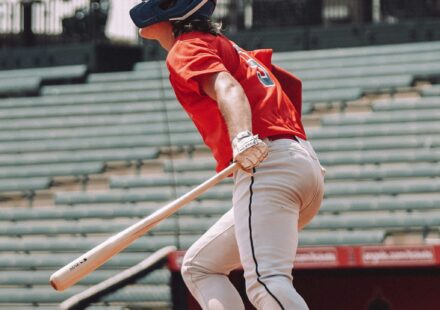 A baseball player is ready to run to first base.