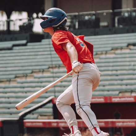 A baseball player is ready to run to first base.