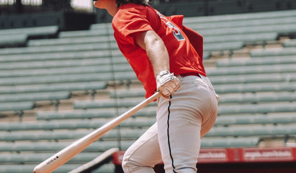 A baseball player is ready to run to first base.