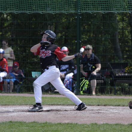 A baseball player lets fly with his bat.