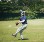 A pitcher is standing in a field, ready to throw the ball.