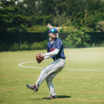 A pitcher is standing in a field, ready to throw the ball.
