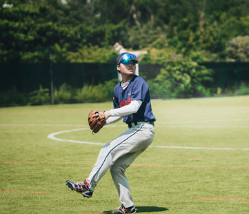 A pitcher is standing in a field, ready to throw the ball.