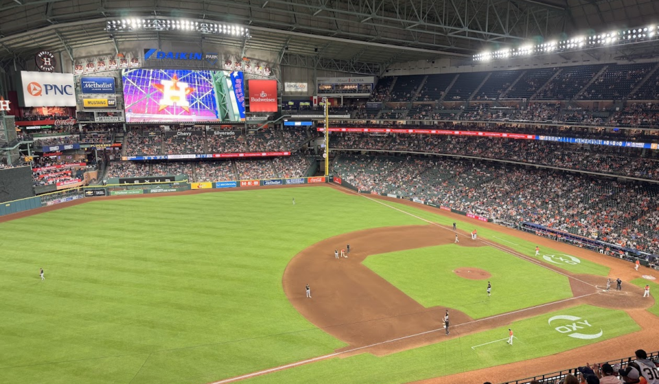 The Astros are on the field at Daikin Park.