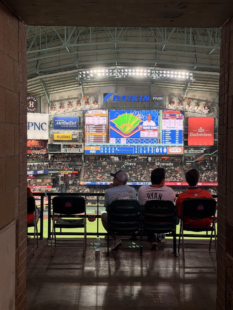 Astros fans sitting at Daikin Park, watching the big screen.