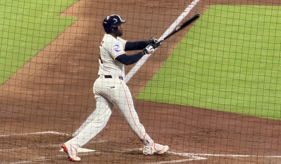 Yordan Alvarez swings the bat at Daikin Park.