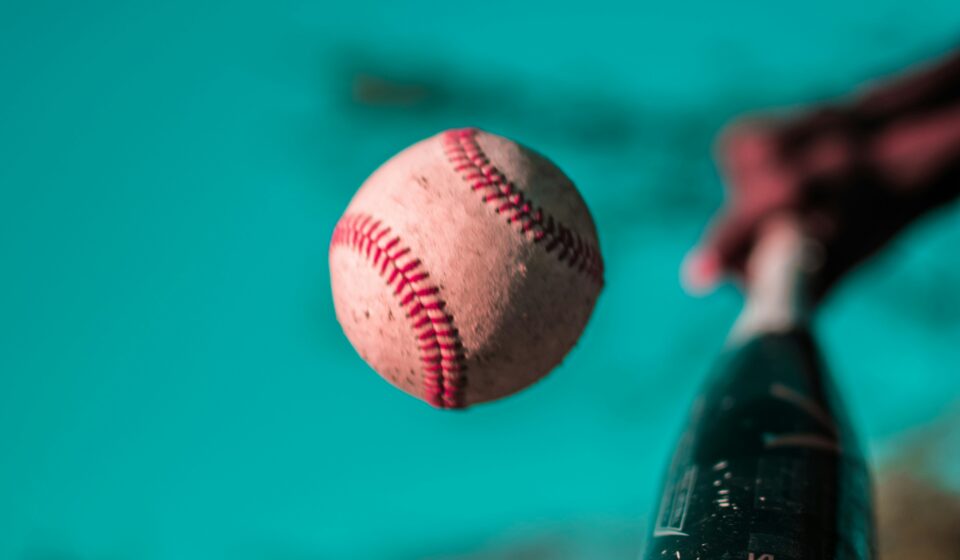 A baseball bat connects with a baseball.