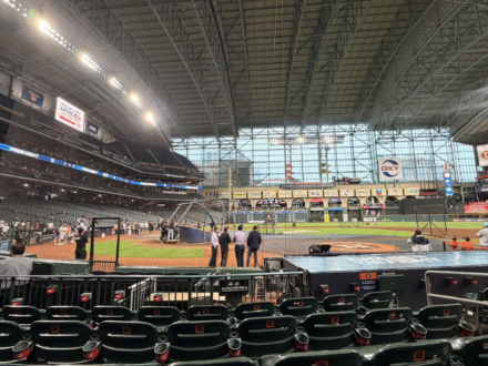Houston Astros players and staff prepare for batting practice at Daikin Park before a game.