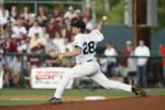 A pitcher extends his back leg while throwing the baseball.