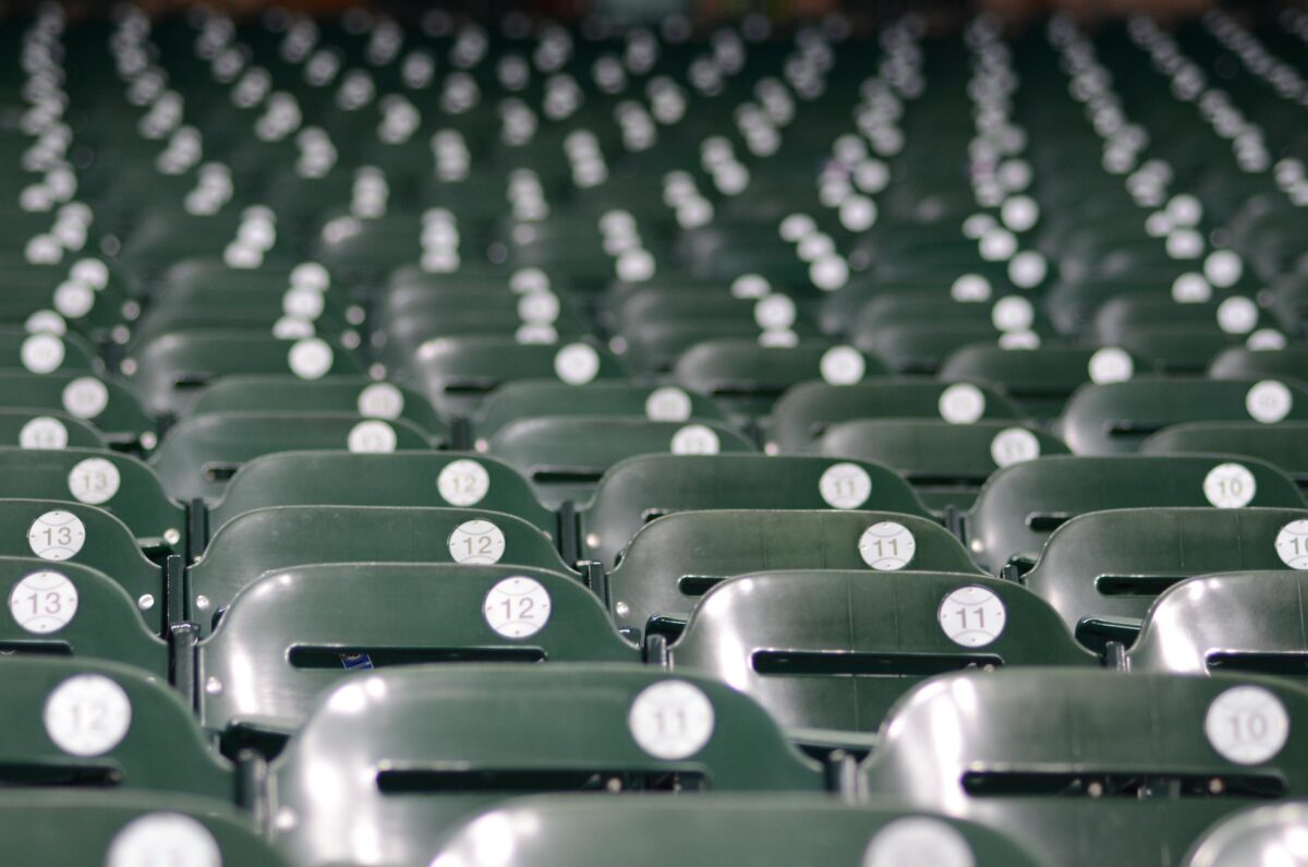 Rows of empty seats in a baseball stadium.