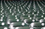 Rows of empty seats in a baseball stadium.